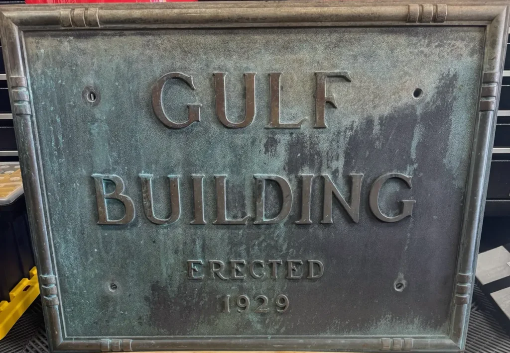 Bronze Gulf Building plaque reading GULF BUILDING ERECTED 1929, with green patina