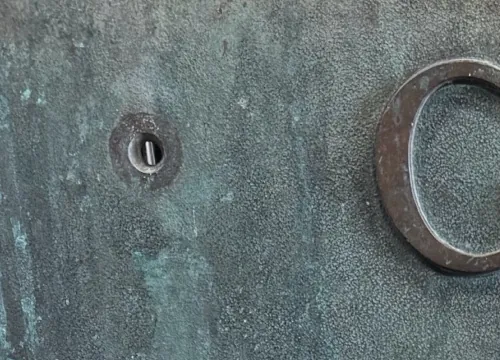 Countersunk mounting hole in the face of the Gulf Building plaque